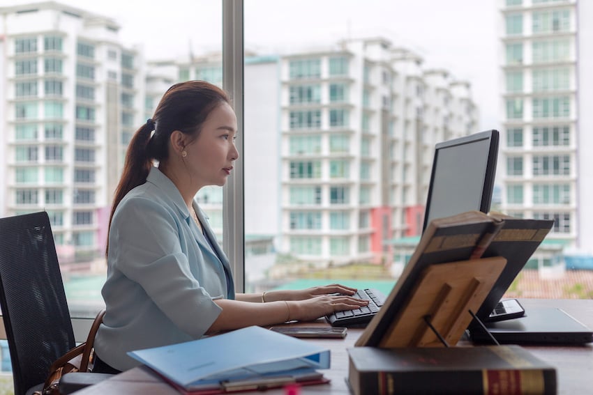 Asian woman working at computer